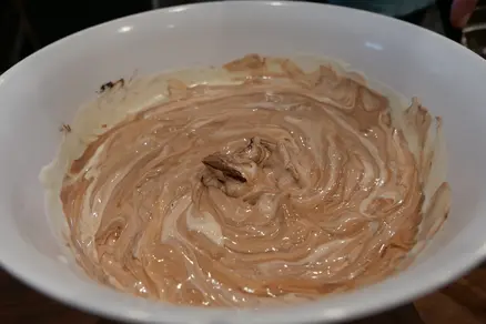 Pale yellow and light brown batter in a swirl.